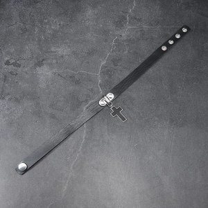 Close-up of black leather choker with silver cross pendant and adjustable metal snaps