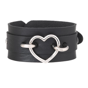 Detail of black leather punk choker with large silver heart buckle and metal rivets