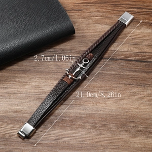 Detail showing the 21cm length and silver anchor pendant of this braided leather bracelet