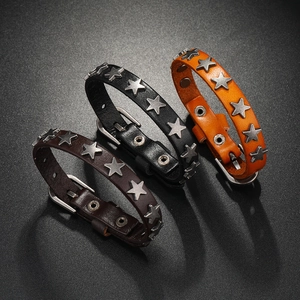 Three punk leather star bracelets in black, orange, and dark brown with vintage metal studs