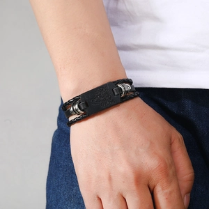 Men's Viking punk braided leather bracelet featuring a silver wolf head charm in black