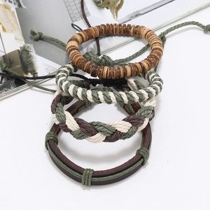 Detailed macro view of four-piece woven leather and wooden bead bracelets in earth tones