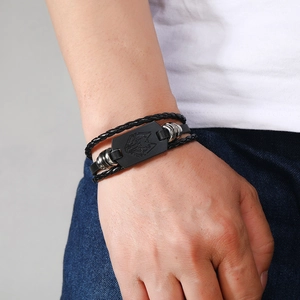 Punk black leather braided bracelet with wolf head engraving on a metal plate charm