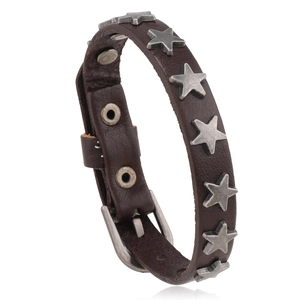 Detailed side view of punk leather bracelet featuring vintage silver star studs and buckle