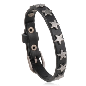 Detail of punk black leather strap bracelet featuring silver star studs and pin buckle