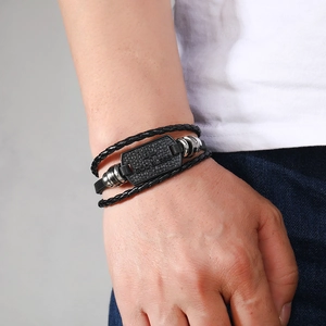 Men's leather braided bracelet featuring a God Bless engraved cross metal charm