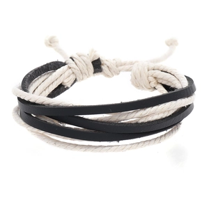 Detail view of woven leather bracelet with black and white cords and adjustable knots
