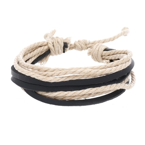 Detail of multi-layer woven bracelet showing beige hemp rope and black leather texture