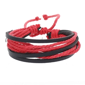 Detail view of a red and black multilayer woven bracelet with adjustable sliding knot closure