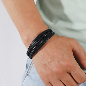Men's multi-layer black braided leather bracelet with secure magnetic clasp on wrist