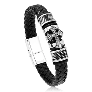 Macro detail of braided black leather bracelet with vintage silver cross and magnetic clasp