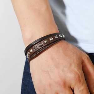 Vintage multi-layer leather bracelet for men featuring silver pyramid studs and woven ropes