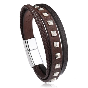 Detail of multi-layer leather bracelet with silver pyramid studs and magnetic steel clasp