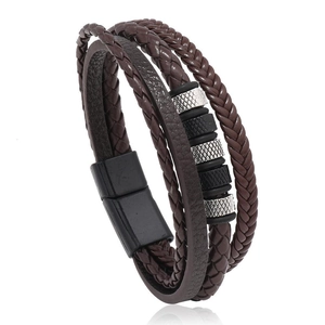 Macro detail of multilayer braided leather bracelet with magnetic buckle and metal beads