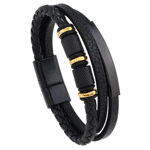 Detail of multi-layer leather braid bracelet for men with gold rings and magnetic clasp