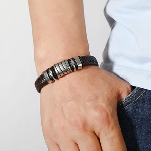 Men's retro brown braided leather bracelet with six silver metal rings on a model wrist