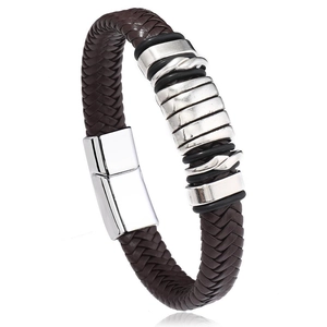 Detail of dark brown braided leather bracelet with silver metal rings and secure buckle