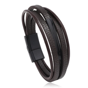 Close-up of braided dark brown leather bracelet with a black magnetic metal clasp
