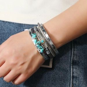 Bohemian multi-layer leather bracelet featuring turquoise stones and a vintage feather charm