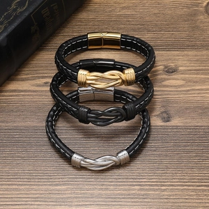 Detail of three-piece woven leather bracelets with gold, silver and gunmetal magnetic clasps