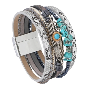 Detail of bohemian layered bracelet with feather charm, turquoise stones, and magnetic clasp