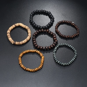 Set of 6 multilayer elastic wooden bead bracelets in natural earthy tones on grey surface