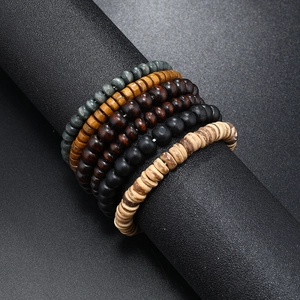 Handmade multilayered wooden bead bracelets in earthy tones on a professional display
