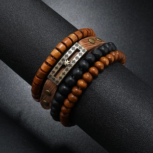 Detail of vintage multilayer men's bracelet set with wooden beads and leather straps