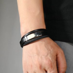 Close-up of men's multilayer braided leather bracelet with polished steel magnetic clasp
