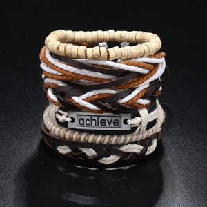 Macro detail of multi-layer leather bracelet set with vintage achieve metal plate