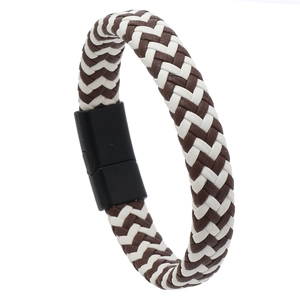 Detail of brown and white braided leather bracelet with a matte black magnetic clasp