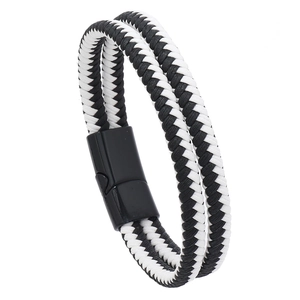 Close-up of double-layer black and white braided leather bracelet with black magnetic clasp