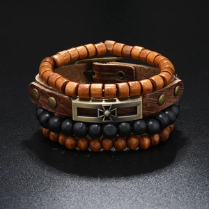 Detail of vintage multilayer leather bracelet set with wooden beads and metal cross