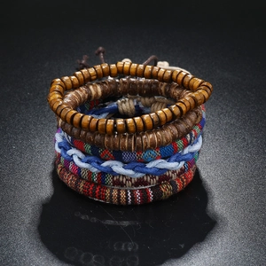 Bohemian woven friendship bracelets set with wooden beads and colorful fabric textures