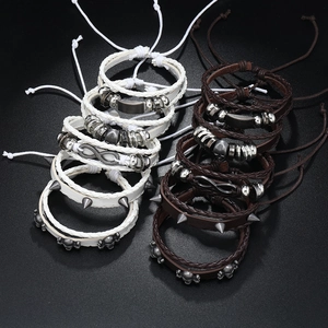 Detailed view of punk multi-layer leather bracelets with skull and infinity symbols