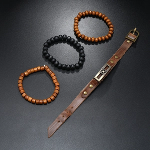 Macro shot of vintage leather bracelet set with cross metal plate and layered beads