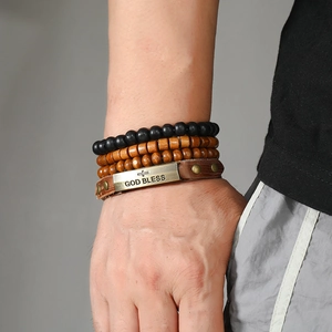 Detail of multi-layer leather bracelet with cross engraving and wooden beads for men