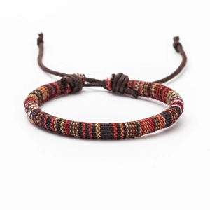 Detail of bohemian woven friendship bracelet with colorful threads and adjustable wax cord