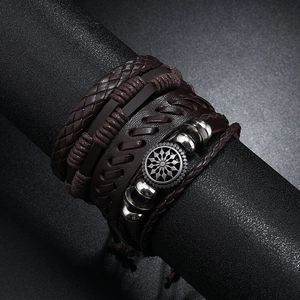 Multi-layer braided leather bracelet for men featuring a vintage silver sun medallion