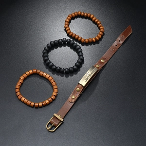 Detail view of multi-layer leather bracelet set with God Bless cross charm and wooden beads