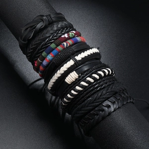 Set of multilayer braided leather bracelets with ethnic woven patterns on a display stand