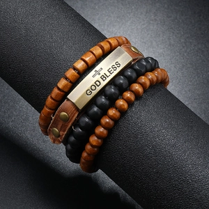 Detailed close-up of multi-layer leather bracelet set with God Bless metal plate