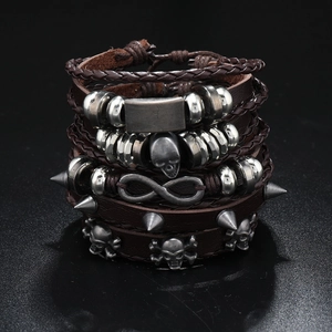 Detail view of punk skull bracelet with leather cords and metallic infinity charms