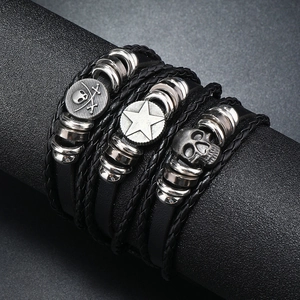 Detailed shot of multi-layer leather bracelets with skull and nautical silver charms