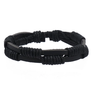Detail of multi-layered black braided leather bracelet with woven cord texture