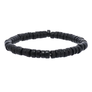 Macro shot of matte black wooden beads and textured disc components on braided bracelet