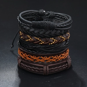 Detail of vintage multilayer braided leather bracelets with antique bronze beads