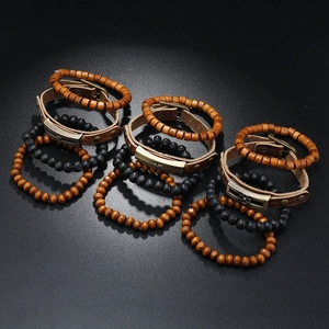 Detail of vintage leather multi-layer bracelets with God Bless engraved metal plate