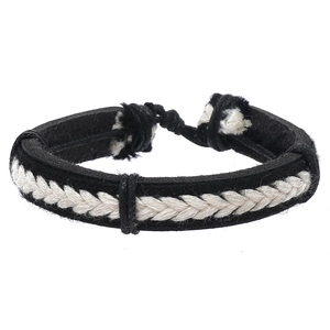 Close-up of bohemian woven leather bracelet set in black and white braided pattern