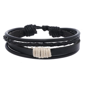 Detail of multi-layer woven leather bracelet featuring black braids and adjustable knot
